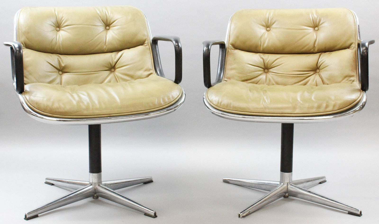 Pair of Knoll arm chairs: A pair of Knoll Associates arm chairs. Green leather seat and back with black covered arm rests. Chrome and steel. Original labels.