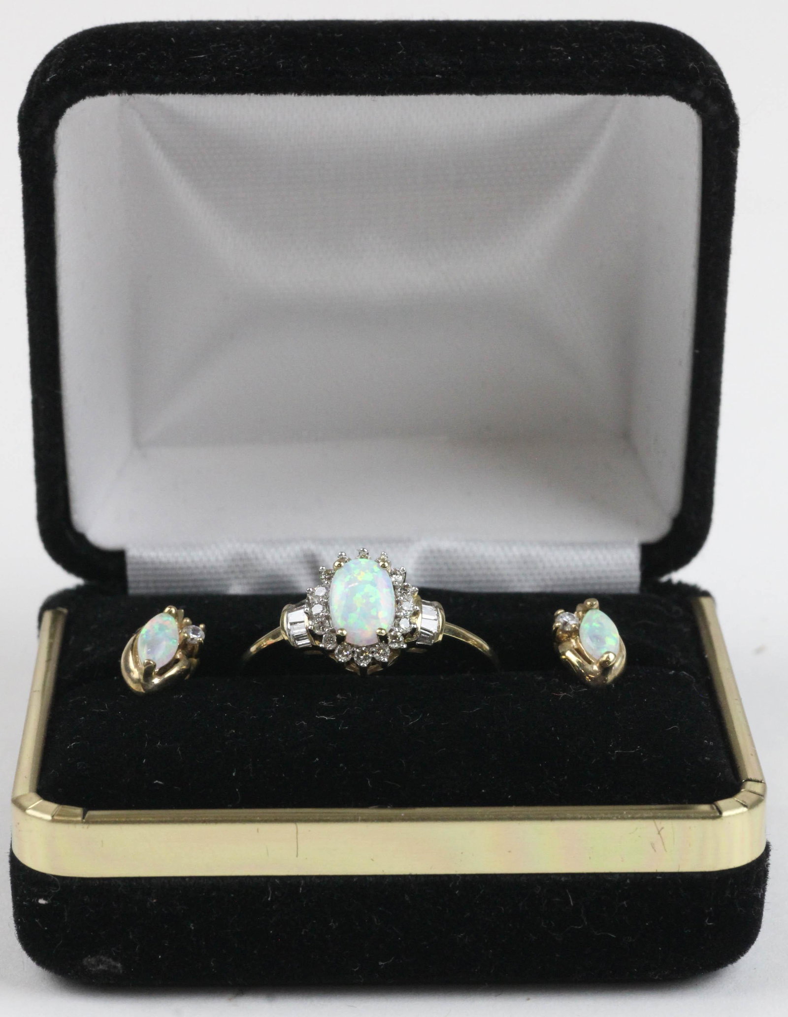 10k, opal, and diamond ring and earrings: A 10 k yellow gold opal and diamond ring and pair of earrings. Ring set with an oval 7 mm x 5 mm opal and 18 .02 CT rd. cut diamonds in surround ring size 6.5. Earrings each with a oval 6.5 m x 3 mm o