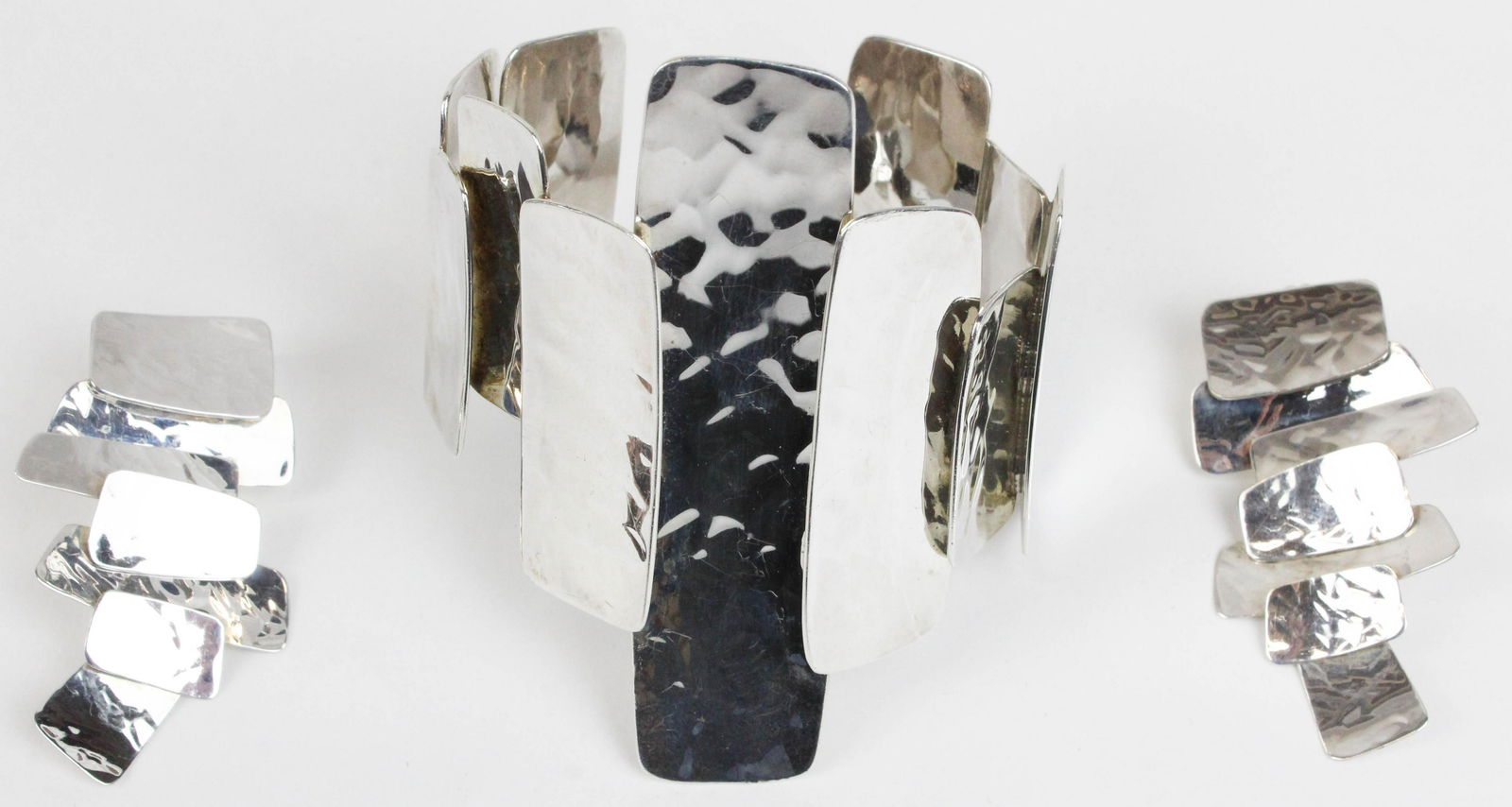 Robert Lee Morris sterling 3 piece set: Robert Lee Morris sterling 3 piece set. Modernist hammered panel bracelet (3" wide at widest point). Pair of earrings earrings each 2" long and 1" wide at widest point.