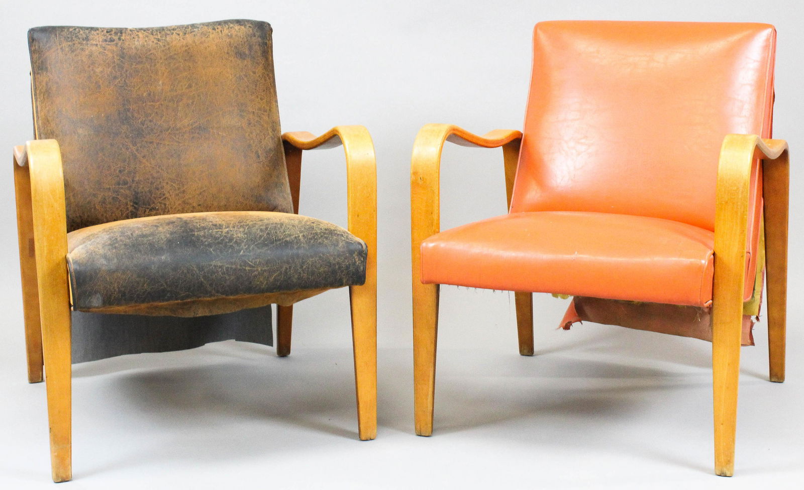 Pair of mid century arm chairs: A pair of mid century arm chairs. Laminated maple bent wood arms. One in leather other in red naugahide.
