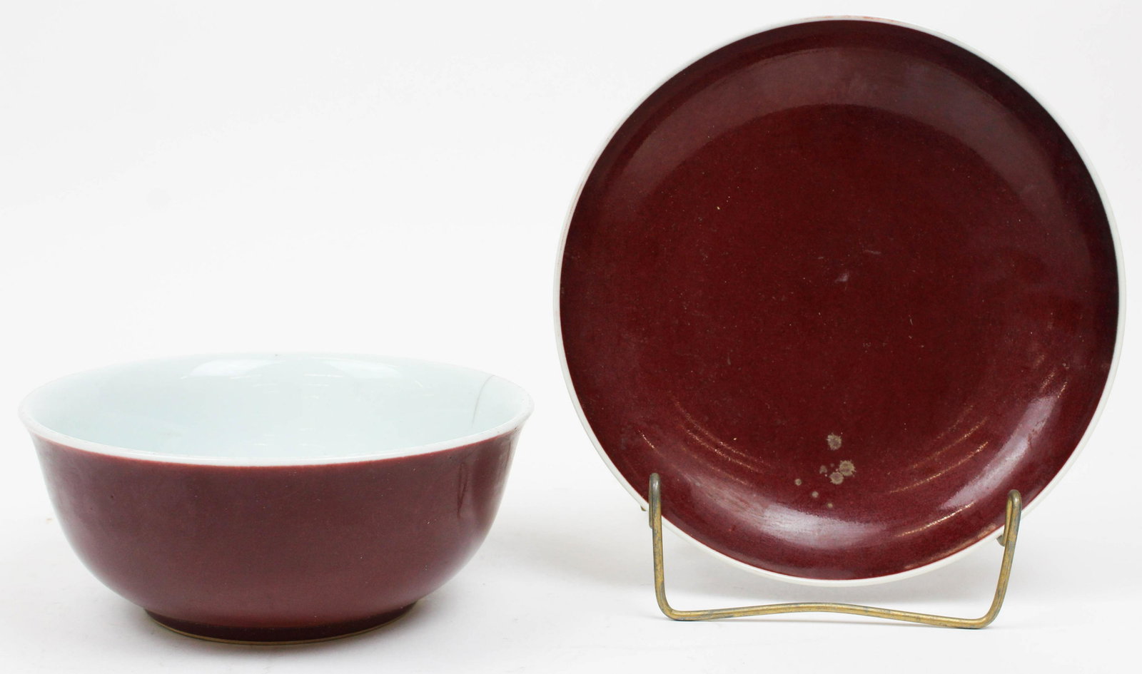2 20th c Chinese Sang de Boef Bowls: 2 early 20th c Chinese Sang de Boef glaze porcelain bowls (one with hairline), both wth underglaze blue Dynastic markings, diameters 7 1/2", 8 3/4"