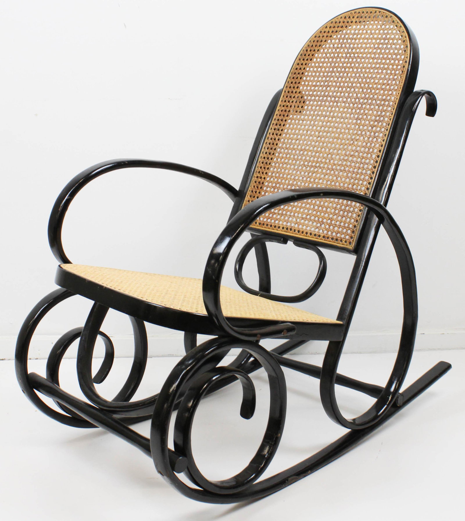 Thonet style rocker: Thonet style rocker in black. Cane seat restored.