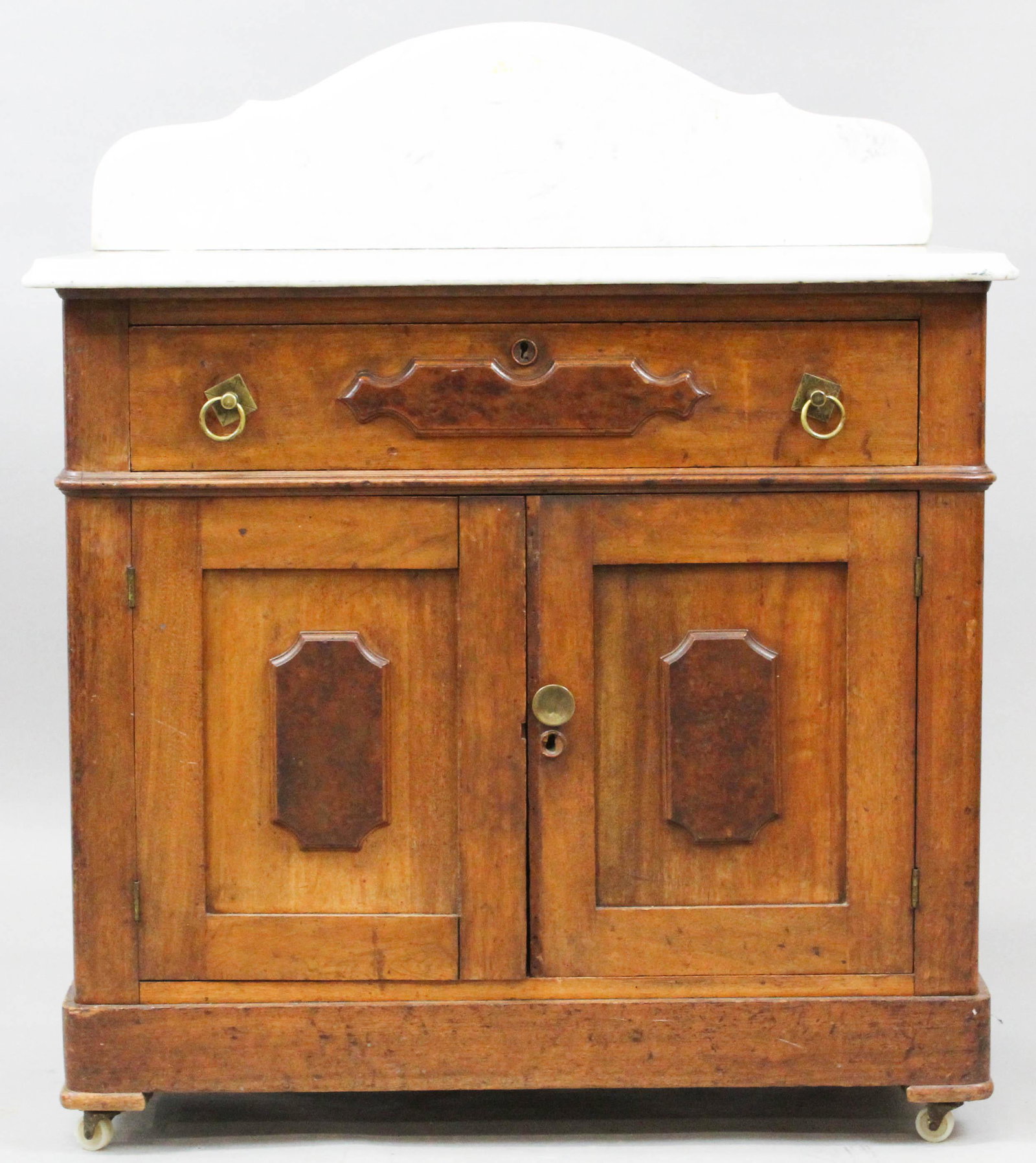 Victorian marble top walnut commode: Victorian marble top walnut commode with burl panels.