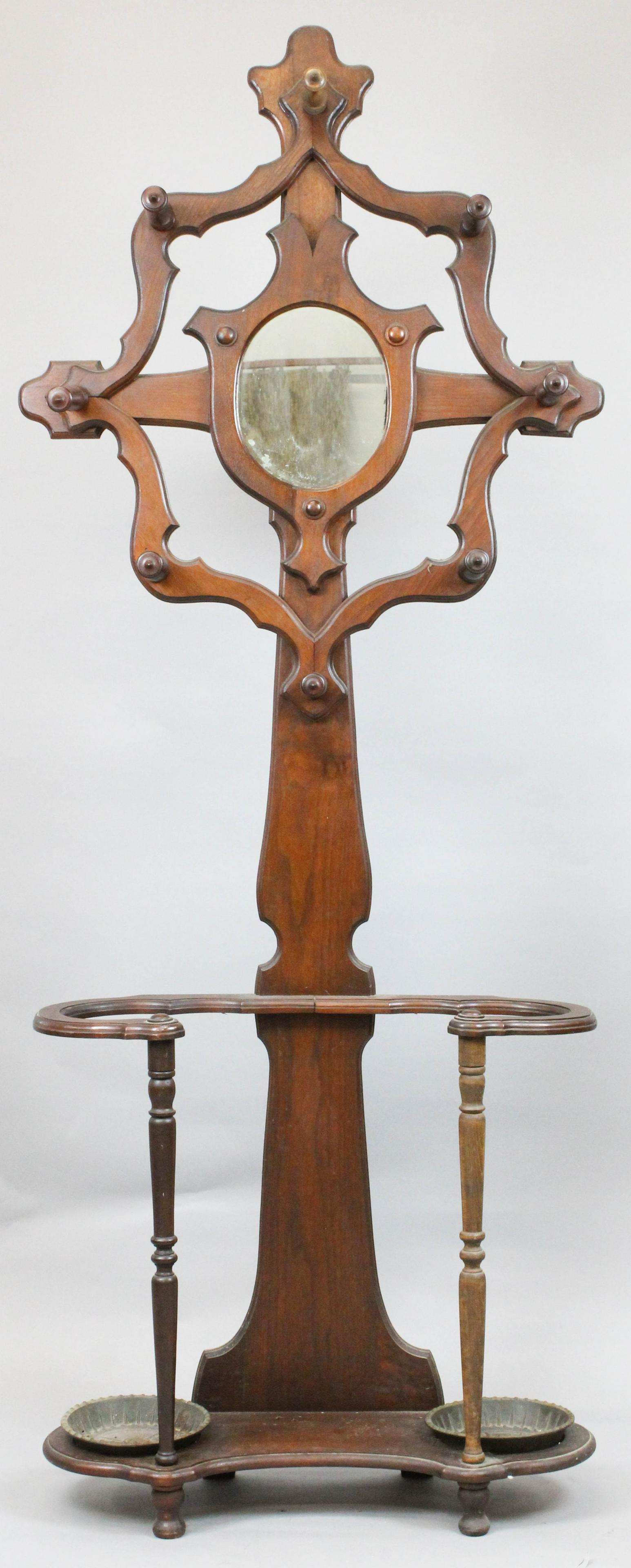 Victorian walnut mirror back hall tree: Victorian mirror back walnut hall tree & umbrella stand. Cast iron inserts. 7' high.