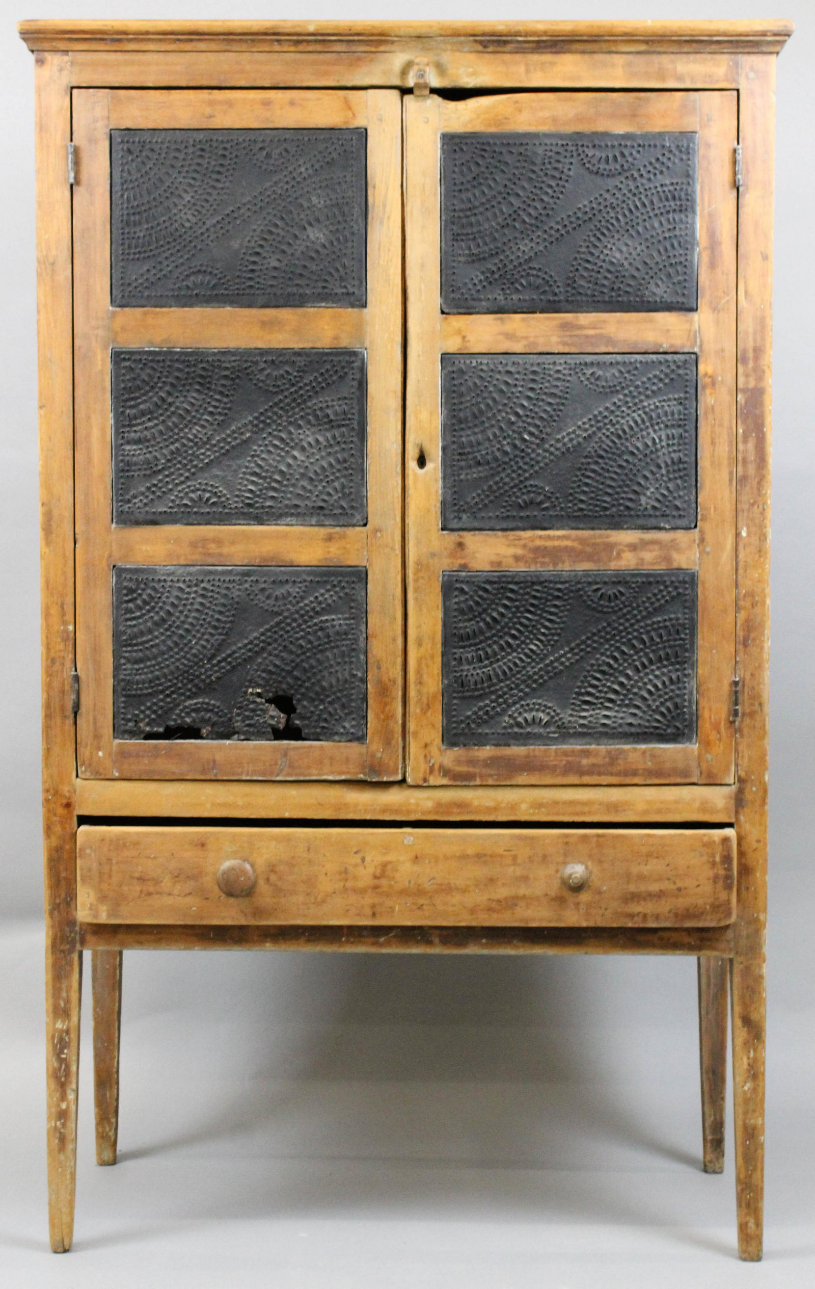 19th c Ohio river valley tin pie safe: 19th c Ohio river valley basswood two door pie safe with pierced tin paneled doors. 63" h x 39" wide. Tin panel ends. Single lower drawer. High base. Dry surface.
