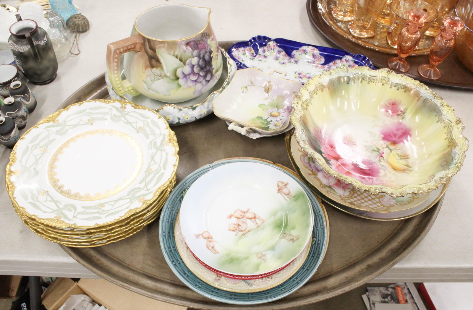 Lot of Limoges, Majolica and Other Porcelain: Lot of porcelain including 6 Jean Pouyat bamboo decorated dinner plates, Jean Pouyat handpainted pitcher artist signed "E.V. Walker", Bavarian and Prussian china dishes, Rose O'Neill Kewpie Plate, maj