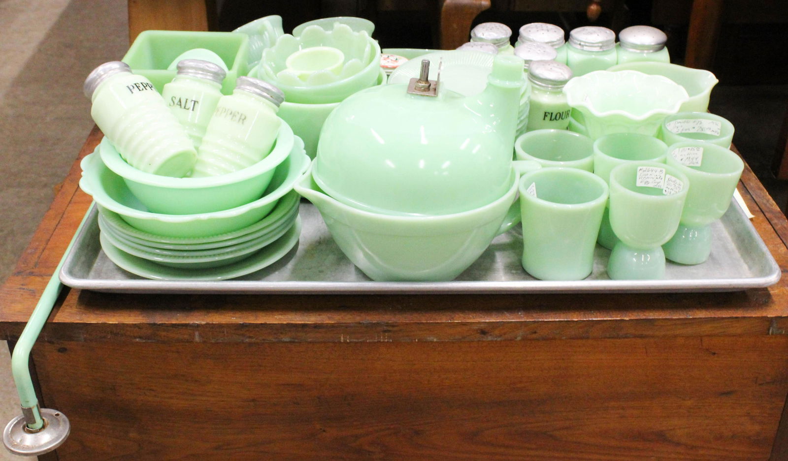 Collection of 1930's Jadeite Glass Kitchenware: Collection of 68 pcs. 1930's Jadeite Glass Kitchenware including 10 range shakers, batter bowls, pitchers, Jane Ray and Alice pattern teacups and saucers, Fire King mugs, 4 egg cups, scarce towel bar,