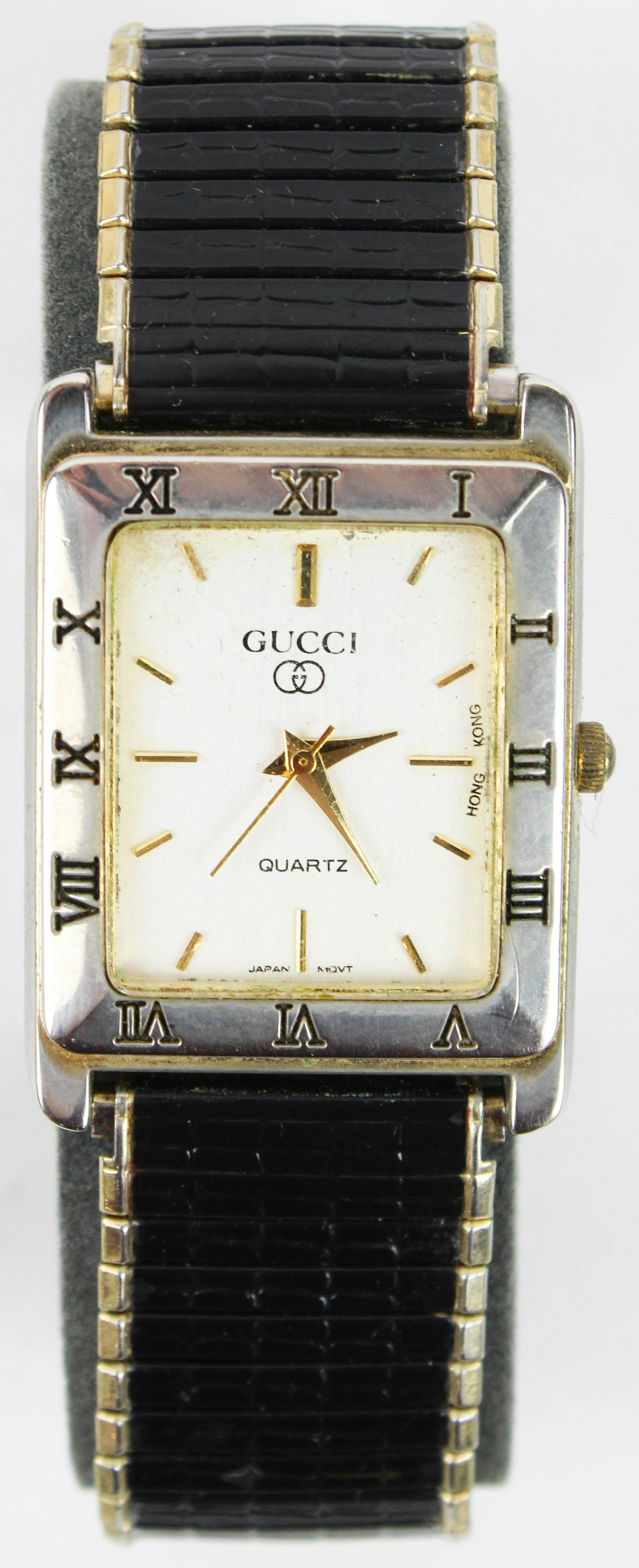 Vintage Men's Gucci wrist watch: Vintage Men's Gucci wrist watch. Black elastic metal wrist band with gold trim. Rectangular case. Face marked Gucci, Quartz. Japan movt. Hong Kong.