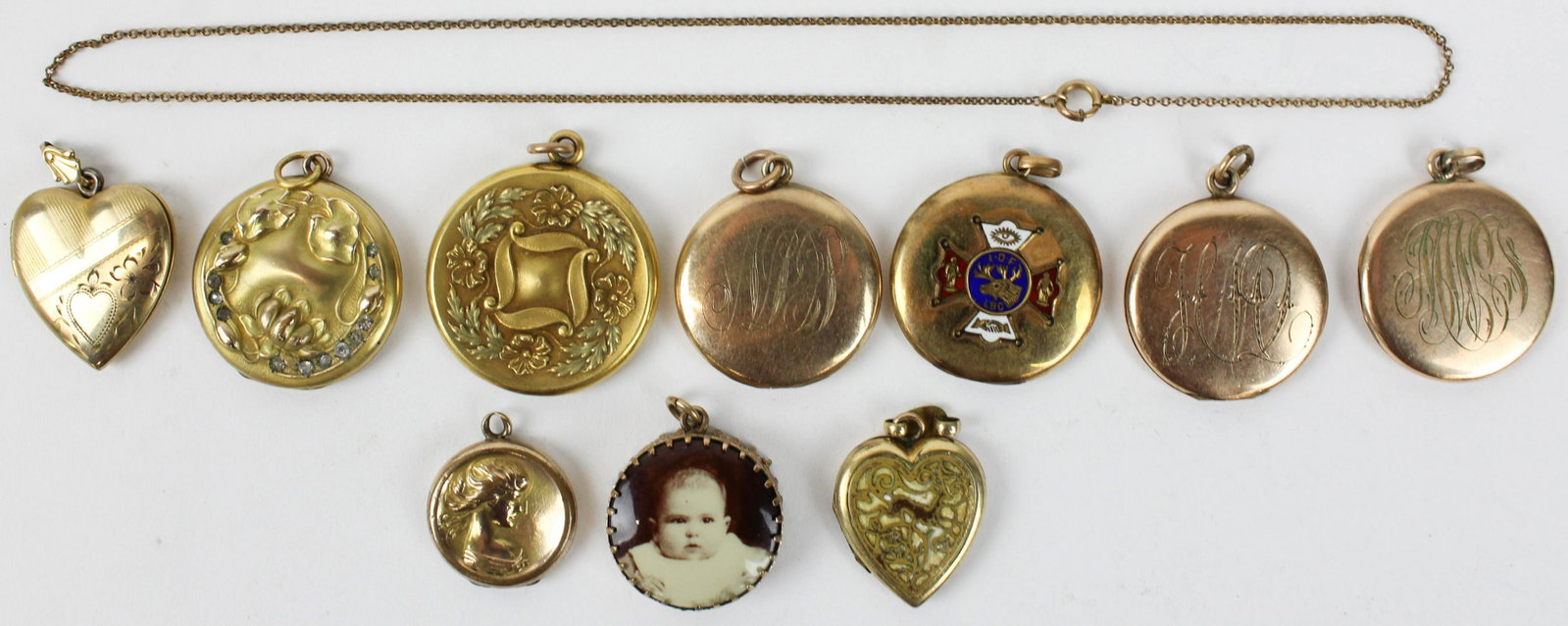 10 Victorian lockets: A group of 10 Victorian memory lockets. Rolled gold with fraternal, Jenny Lynn, floral, and two tone.