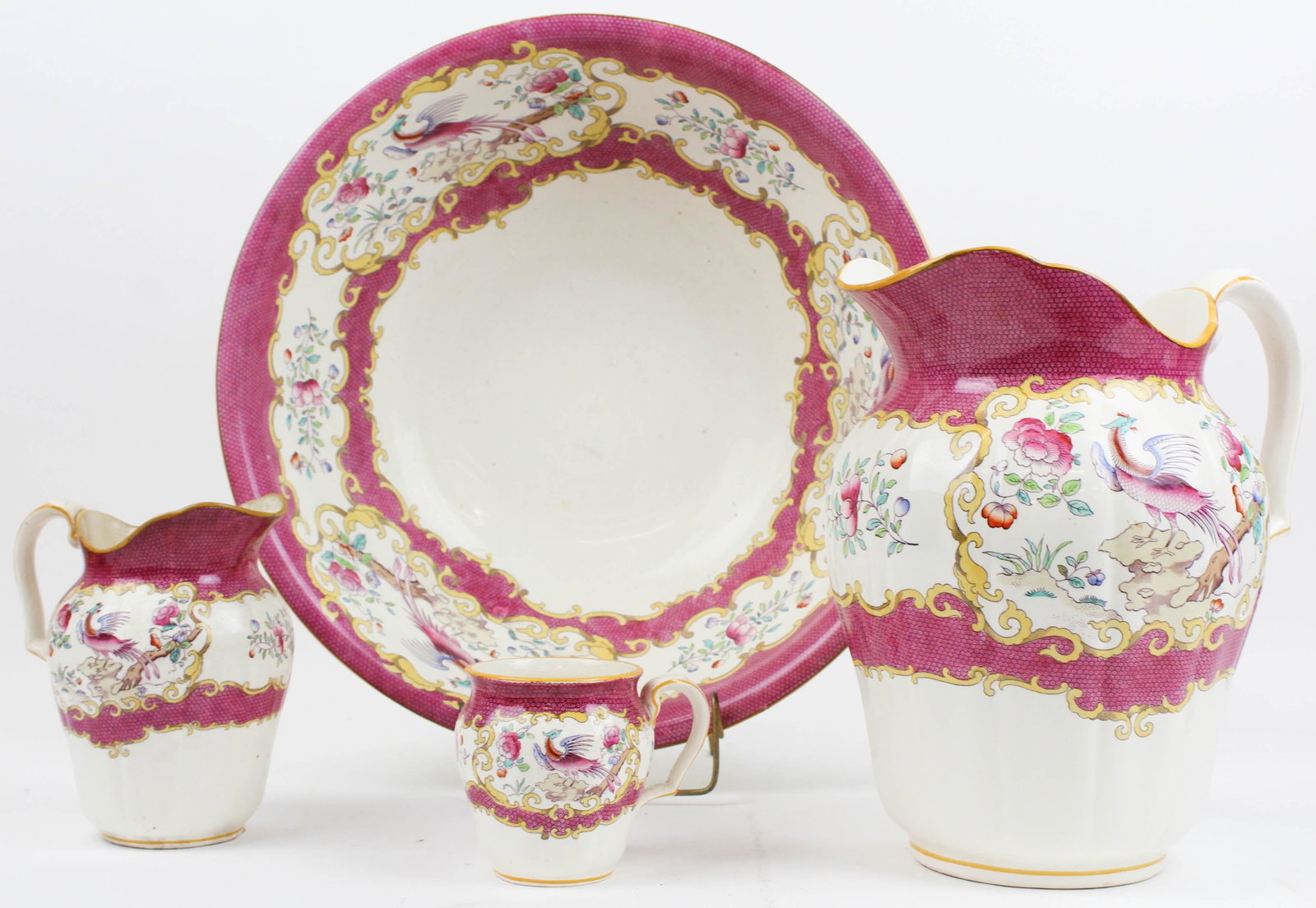 Minton Porcelain Wash Bowl and Pitcher Set: Minton "Cockatrice" pattern English porcelain wash bowl and pitcher set with bold bird of paradise transfer decoration, retailed by Gilman, Collamore, & Co. Fifth Ave. NYC, accompanied by mug and smal
