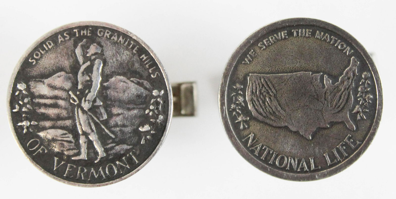 Tiffany sterling cufflinks Vermont National Life: A pair of sterling cufflinks. Round design one with motto " solid as the granite hills of Vermont" with possible image of Ethan Allen, and other with "we serve the nation National Life" motto. 3/4" di