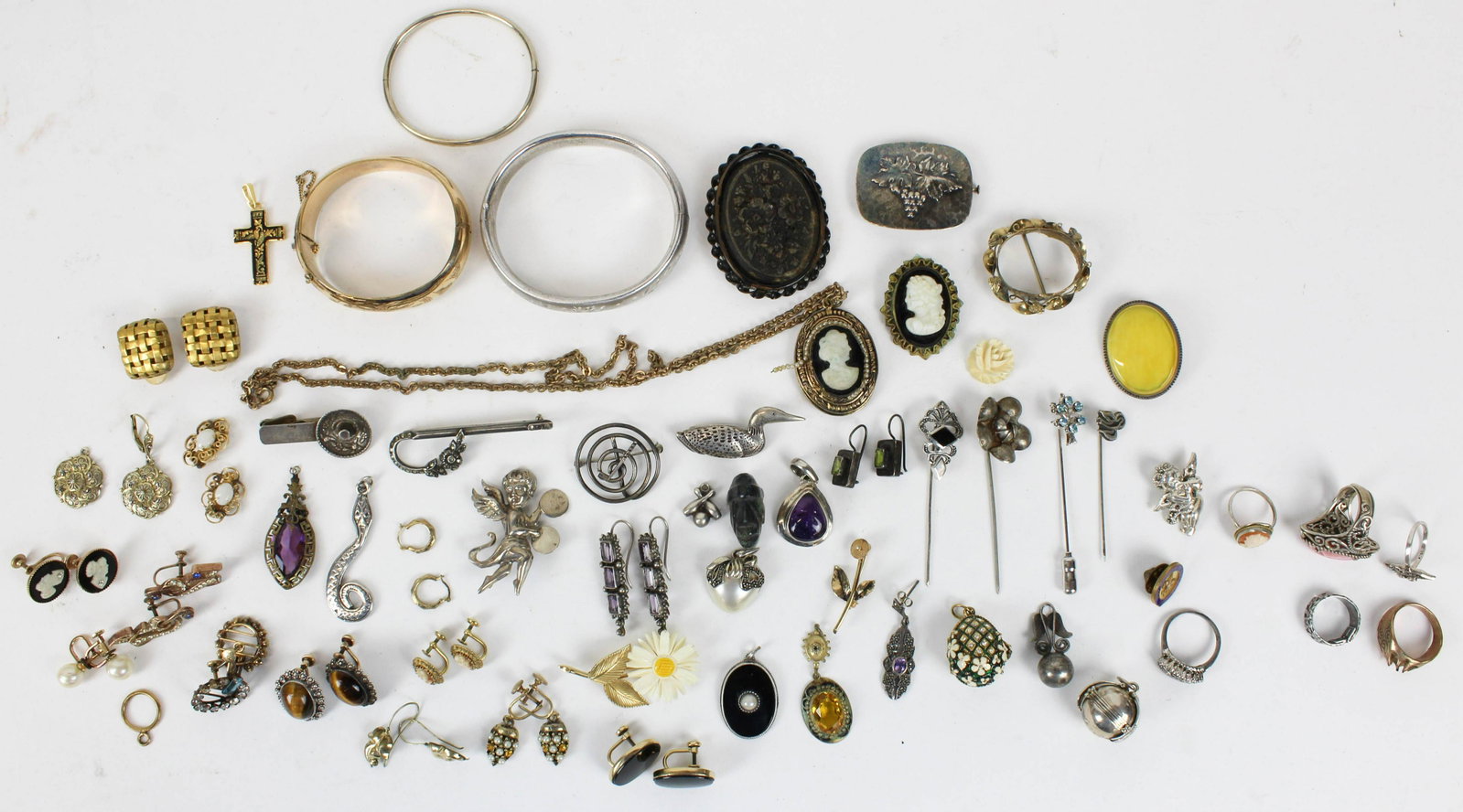 A group of costume & sterling jewelry.: A group of costume & sterling jewelry including sterling rings, earrings, brooches, cats eye earrings, costume earrings, and more.