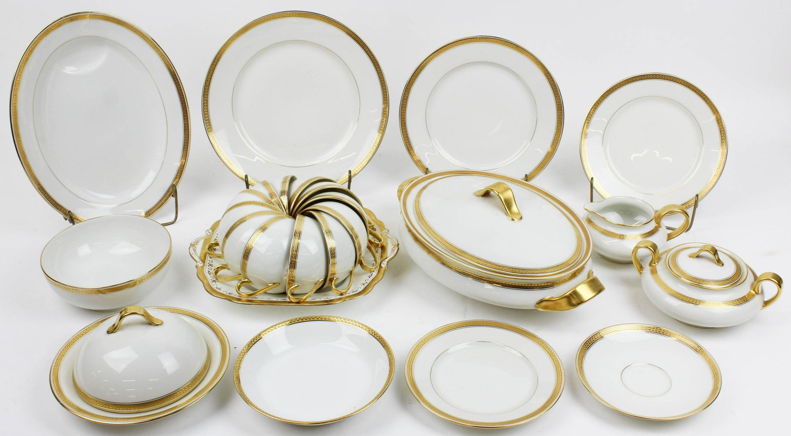 114 pcs. Theodore Haviland Limoges Dinnerware: 114 pcs. Theodore Haviland Limoges Porcelain Dinnerware with gilt engraved gold band rims, including dinner plates, side plates, sugar and creamer, oval serving dish, 3 platters, tea cups and saucers,
