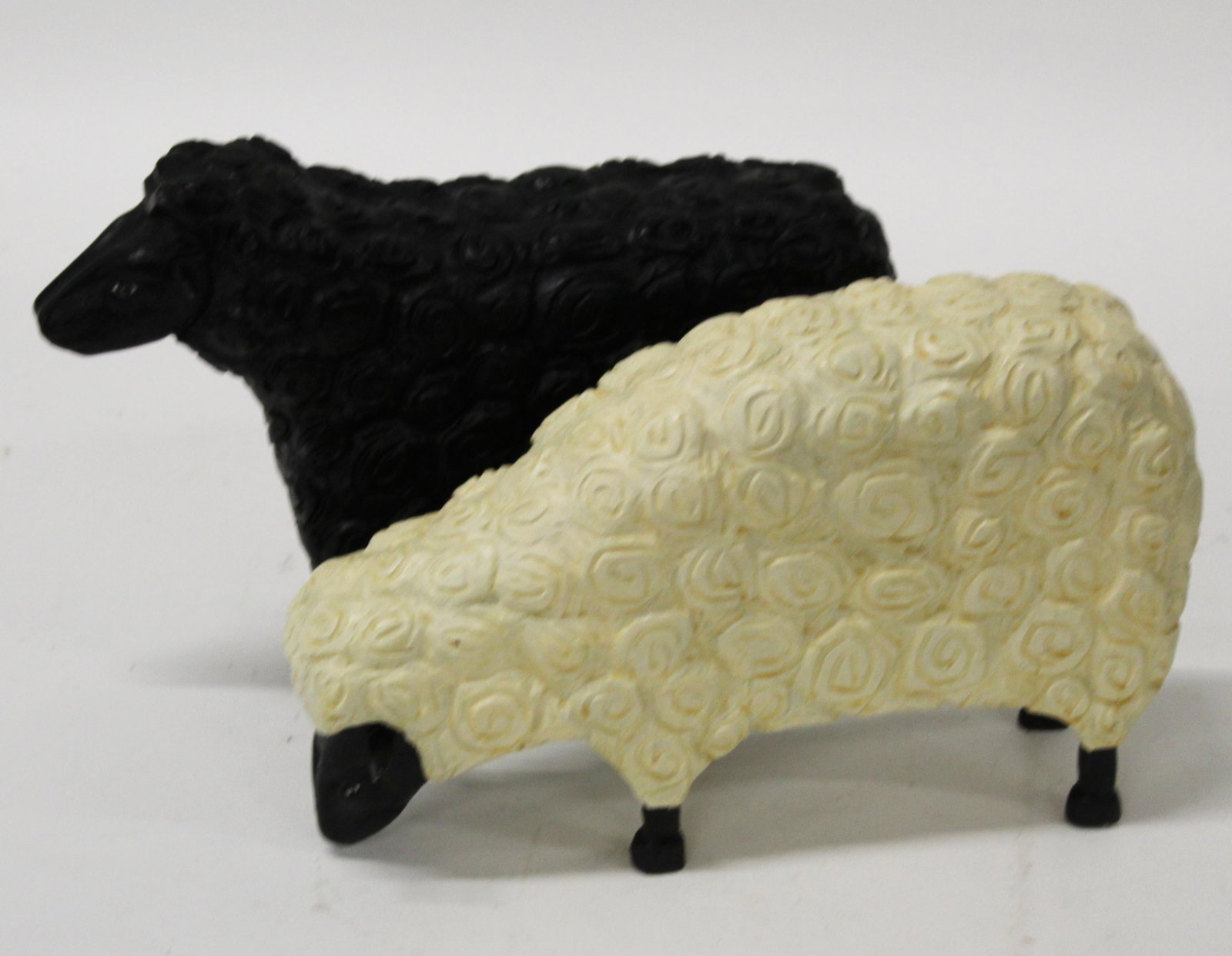 Stephen Huneck (VT 1948-2010) Two Sheep figures: Stephen Huneck (Vermont 1948-2010) Two Sheep figures one black one white signed in gold pen by Huneck. Each 12" long