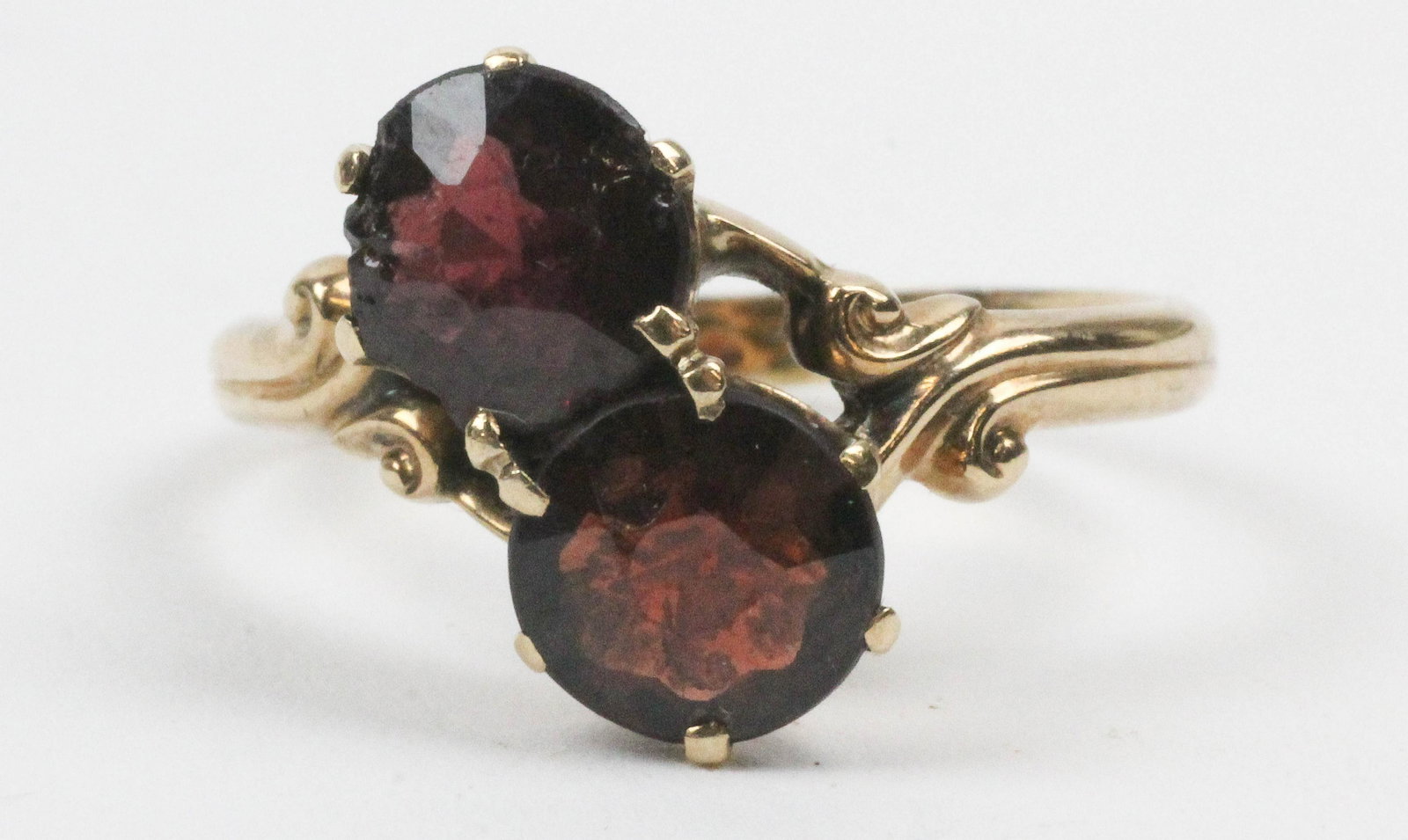 Victorian yellow gold and garnet ring: Victorian yellow gold and garnet ring having two 1 ct round cut garnets (one with chip on edge) set in yellow gold tests 14k. Ring size 6.5