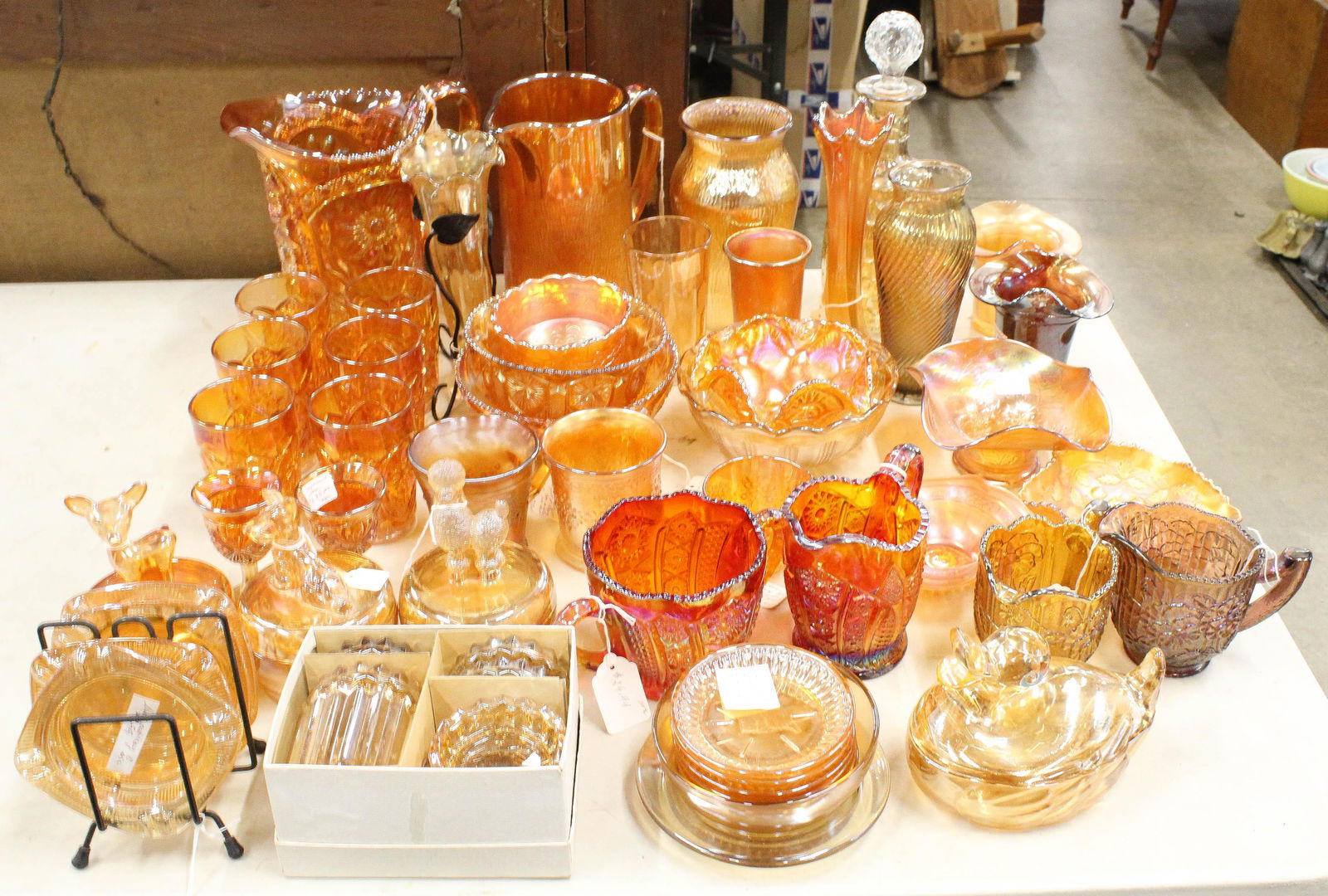 48 pcs. Marigold Iridescent Carnival Glass: Collection of 48 pcs. Marigold Iridescent Carnival Glass in various patterns including Northwood ruffled dishes, 7 pc. Pitcher and tumbler set, Imperial Amberina sugar and creamer, vases, coaster sets