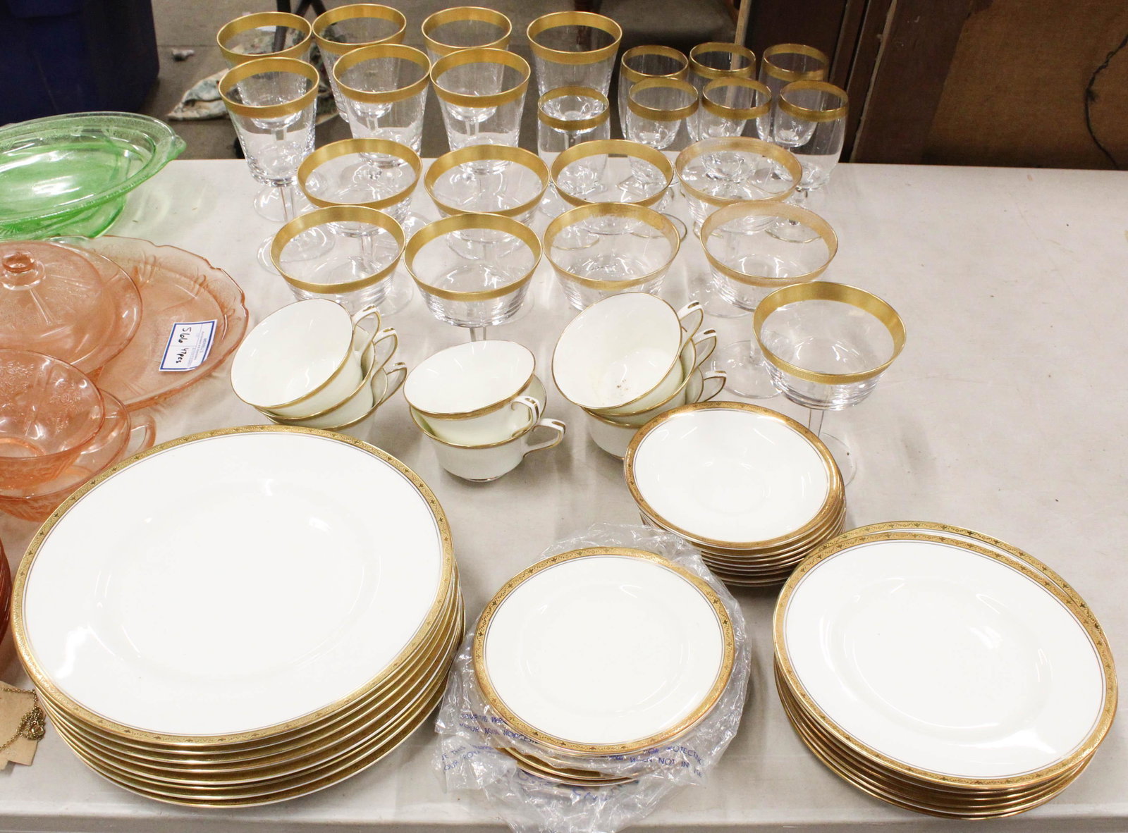40 pcs. Royal Worcester Chancellor Dinnerware: 40 pcs. Royal Worcester "Chancellor" pattern gold banded English bone china porcelain dinnerware, accompanied by 23 pcs. Lenox Georgetown gilt engraved stemware (some wear to gilding)