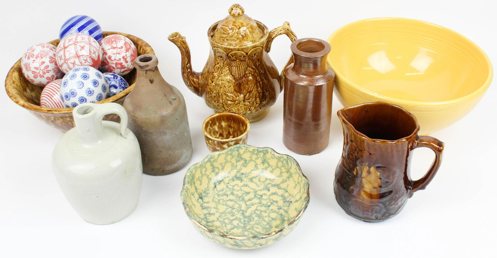 Lot of Rockingham Pottery and Stoneware: Lot of pottery including Rockingham pitcher and rare patriotic teapot (spout damaged), 2 sponge decorated bowls, custard cup, large yellow Fiestaware fruit bowl, 3 stoneware vessels including "City Wi