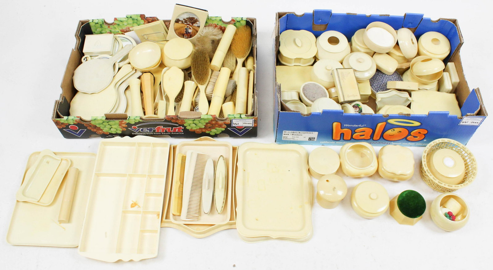 Collection of "French Ivory" Celluloid Accessories: Large collection of "French Ivory" celluloid dresser items and accessories including hand mirrors, brushes, hair receivers, powder jars, toiletry cases, straight razors, portrait frames, jewelry boxes