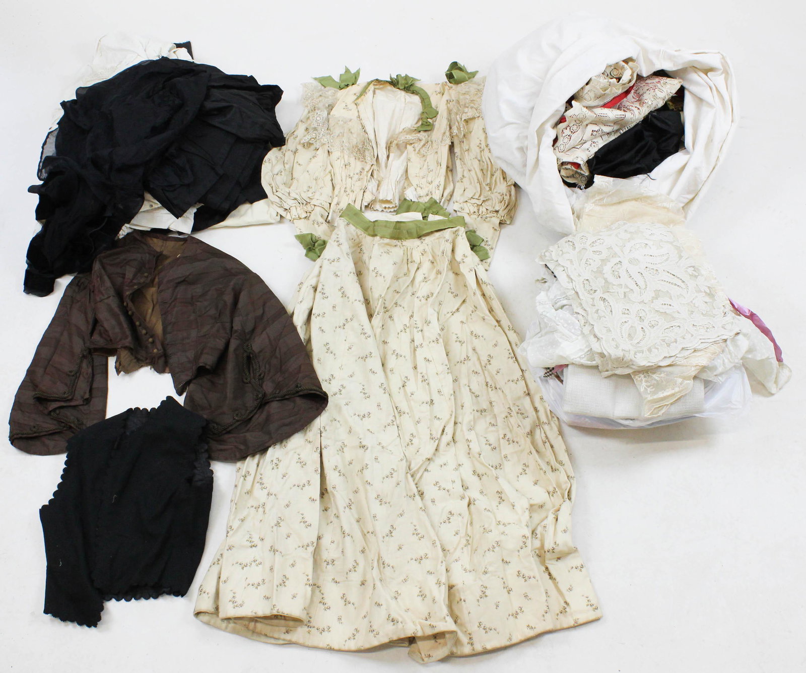 19th and early 20th c. Clothing Fragments: Lot of 19th and early 20th c. Clothing Fragments and material including white embroidered skirts, Victorian shirtwaist tops, lace wraps, vests, etc. -some disassembled clothing articles, extra brocade