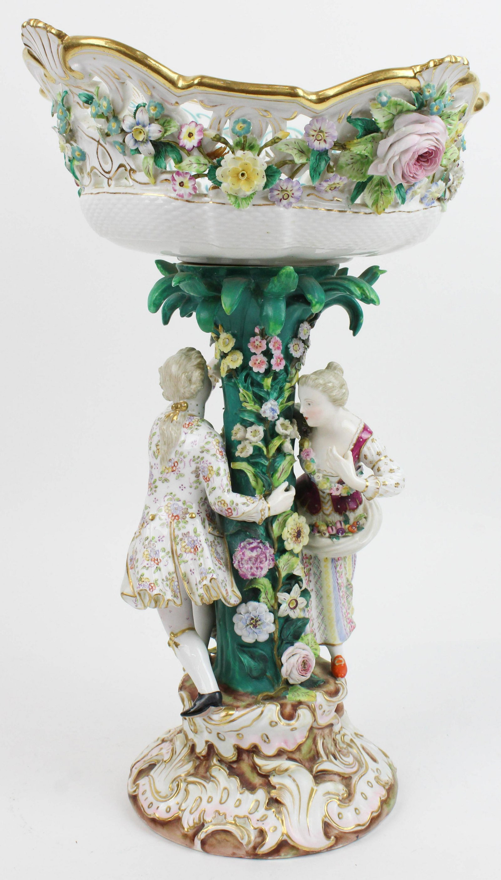 Meissen Porcelain Monumental Figural Compote: 19th c. Meissen porcelain monumental figural compote with reticulated bowl decorated with modeled flowers, stem having romantic couple dancing around tree trunk, figures with delicately hand painted g