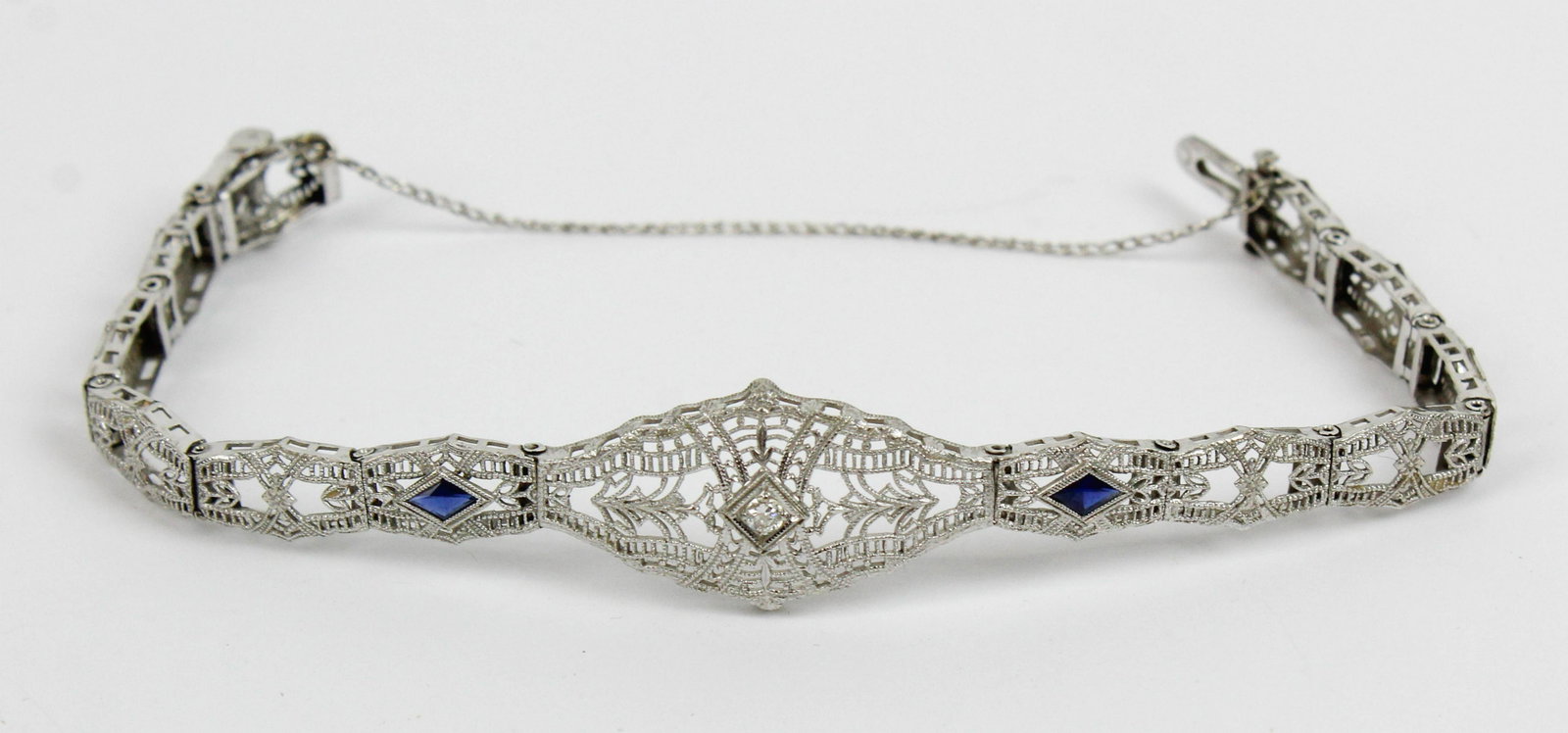 Edwardian open work sapphire & diamond bracelet: Ca. 1900 Edwardian 14k white gold open work bracelet. Set with a .1 ct round cut diamond and two diamond cut .1 ct sapphires. 8.2 grams t.w.