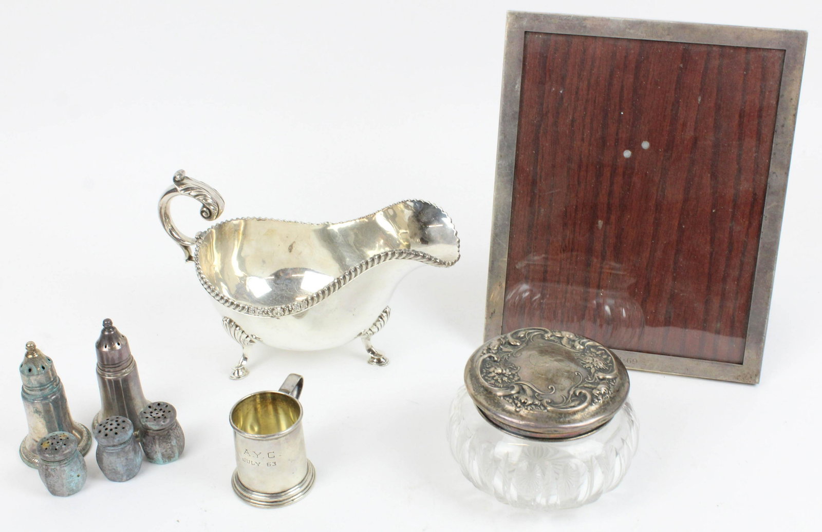 Group of Sterling Silver and Plated Hollowware: Group of sterling silver and plated holloware including sterling picture frame, cut glass dresser jar with repousse lid, Lunt sterling tankard form jigger, 3 small salt shakers, pair of Reed & Barton 