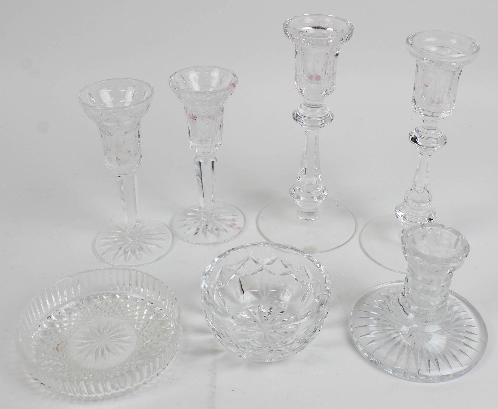 7 pcs. Waterford Irish Crystal Tableware: 7 pcs. Waterford Irish Crystal Tableware including 2 pair of tall candlesticks, small bowl, diamond cut bottle coaster, and single low candlestick ht. 1" -8.25"