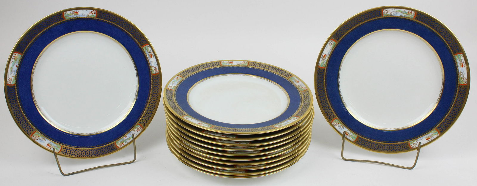 12 Copeland Spode Porcelain Dinner Plates: Set of 12 Copeland Spode English Porcelain Dinner Plates with gold encrusted raised enamel border featuring scenic Orientalist landscape cartouches of fisherman by water, over wide blue bands dia. 10.