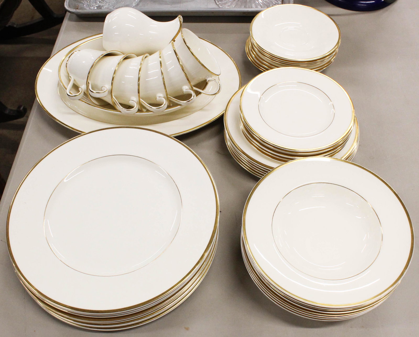45 pcs. Royal Doulton Heather Porcelain Dinnerware: 45 pcs. Royal Doulton "Heather" Pattern Porcelain Dinnerware with simple gold banded rim, including dinner plates, serving bowls, cups and saucers, side dishes, etc.