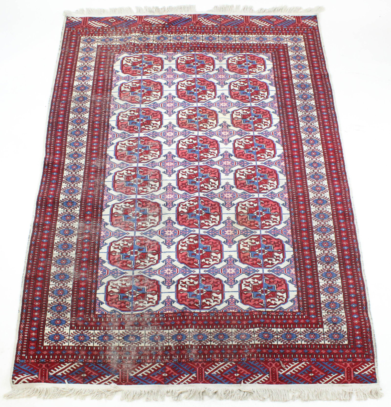 20th c Tekke Area Rug: Earlier 20th c Tekke area rug with 3 rows of 8 guls, white background, 5' 1" x 8', areas of uneven wear, new fringe glued on