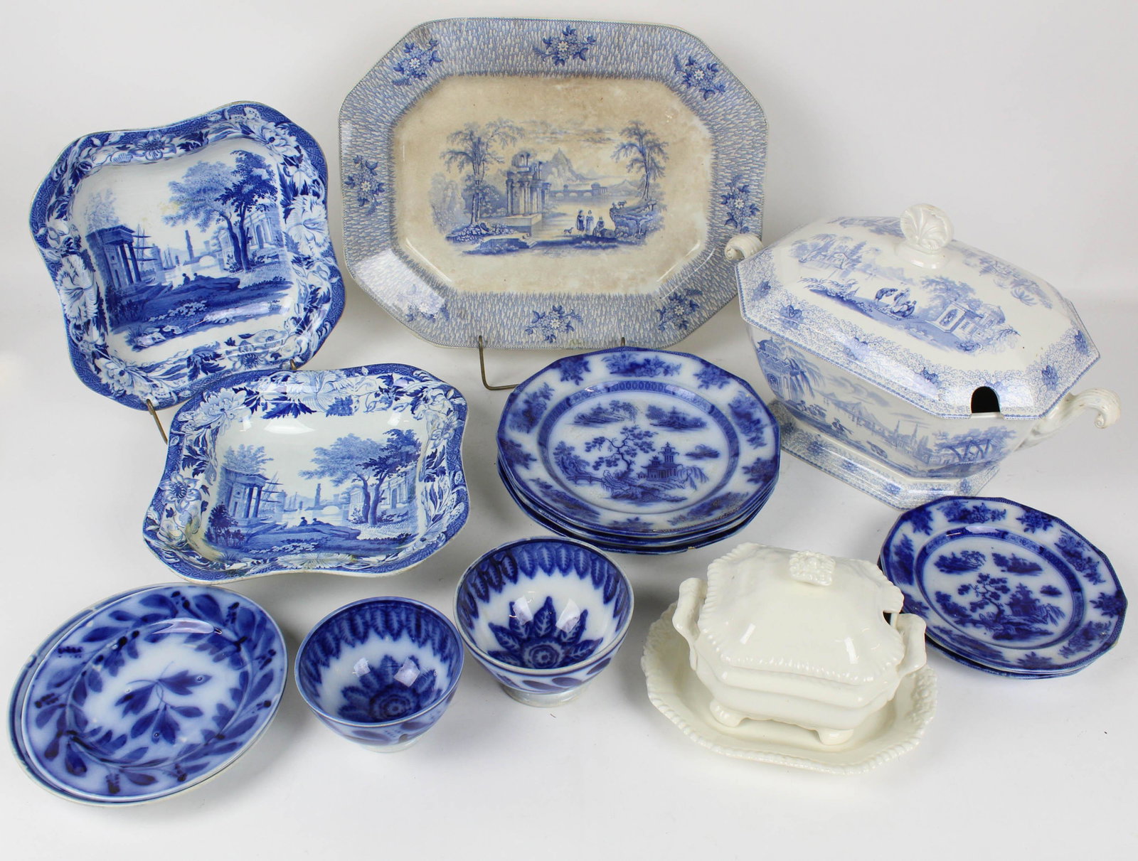 Blue Transferware Tureen, Flow Blue China: Mid-19th c. blue transferware tureen with orientalist scenes, 5 pcs. flow blue ironstone, 4 pcs. stencil decorated flow blue, 2 Wedgwood blue transferware serving dishes (repaired) and a Spode gadroon