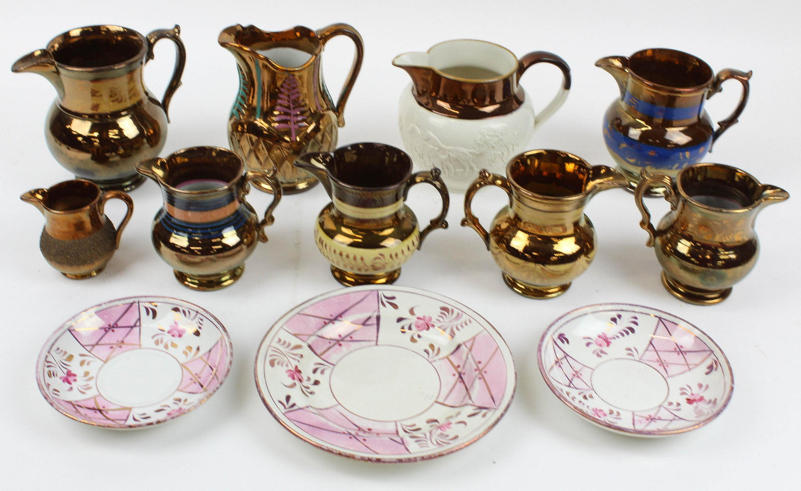 Collection of 9 Copper Lustre Pitchers: Collection of 9 Copper Lustre decorated pitchers, one having embossed Pearlware hunt scene, accompanied by 3 pink lustre decorated plates