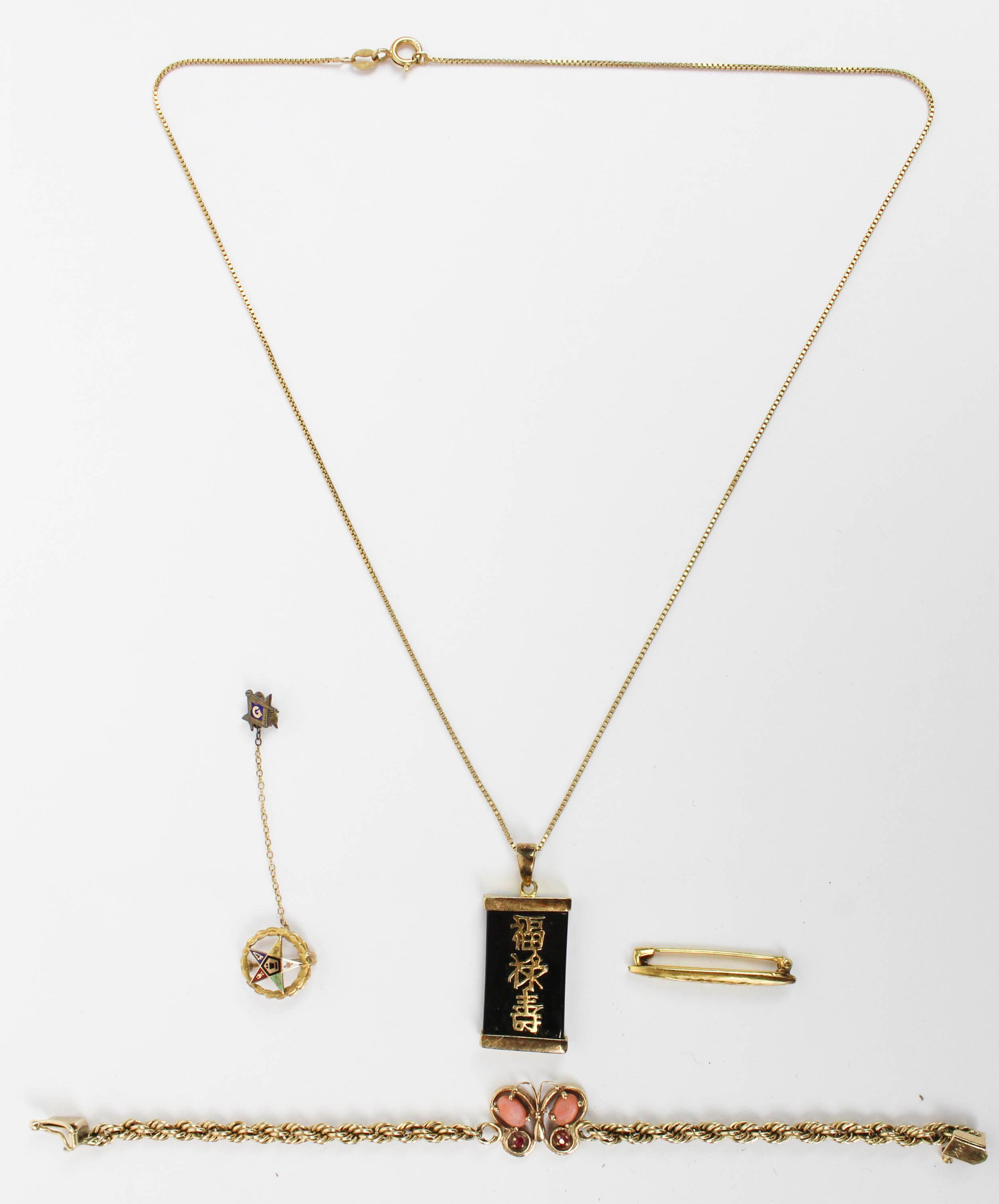 A group of 14k jewelry: A group of 14k jewelry including a bracelet with a coral and ruby butterfly, Chinese gold chain & onyx pendant. Other gold pins. 15.3 grams t.w