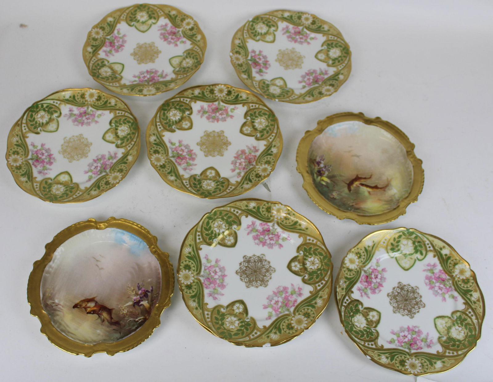 Limoges Porcelain Fish Plates and Dinner Plates: Group of Limoges porcelain plates including two fine scenic hand painted fish plates signed "Muville" by Lazeyras, Rosenfeld, and Lehman with scalloped god encrusted borders (some wear to paint, small