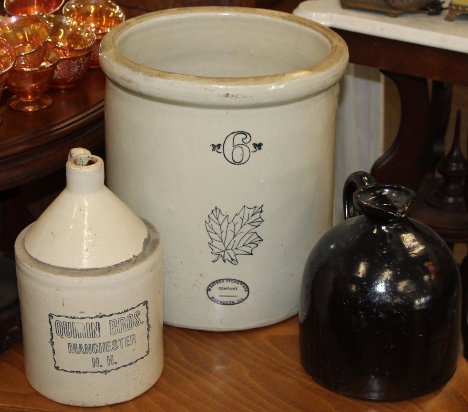 Lot of 3 pcs. Stoneware incl. 6 gal Crock: Lot of 3 pcs. of stoneware including Western Stoneware Co. Monmouth, Ill. 6 gal crock, Quirin Bros. Manchester, NH stenciled merchants jug, dark brown Albany slip decorated jug 10" x 14.5"