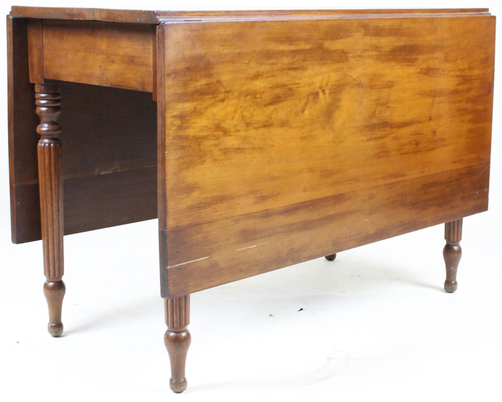 Sheraton cherry deep drop leaf table: Sheraton cherry deep drop leaf table. Reeded swing leg. 42" long.