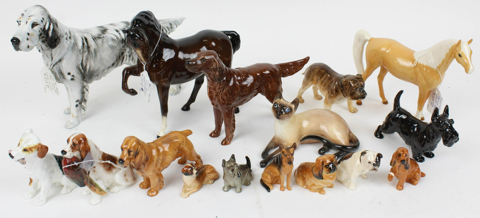 15 Royal Doulton Animal Figurines incl. Dogs: Collection of 15 Royal Doulton English Bone China Animal Figurines including siamese cat, 2 horses, 11 dogs, accompanied by a Beswick Irish Setter figure ht. 1.5"-8"