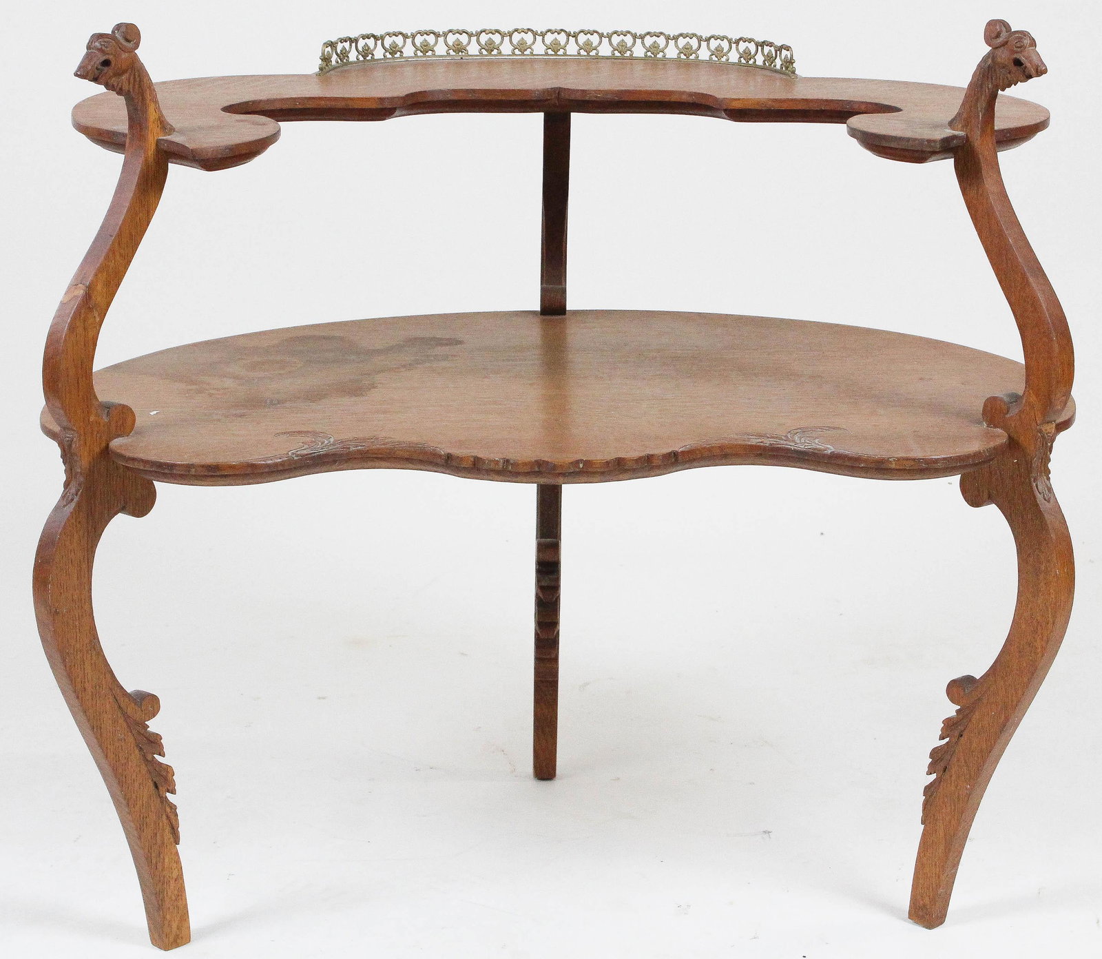 Victorian bird head two tier shelf: Victorian two tier oak shelf with gilt gallery and bird head supports.