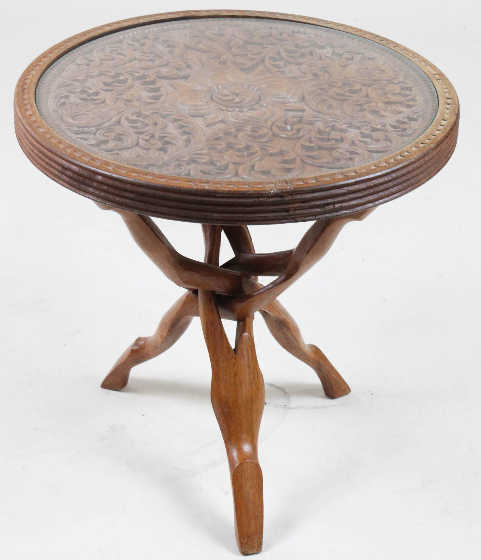 Carved Indian Teak Wood Folding Accent Table: Indian teakwood folding accent table with profusely carved top and folding puzzle base 19.5" x 20"