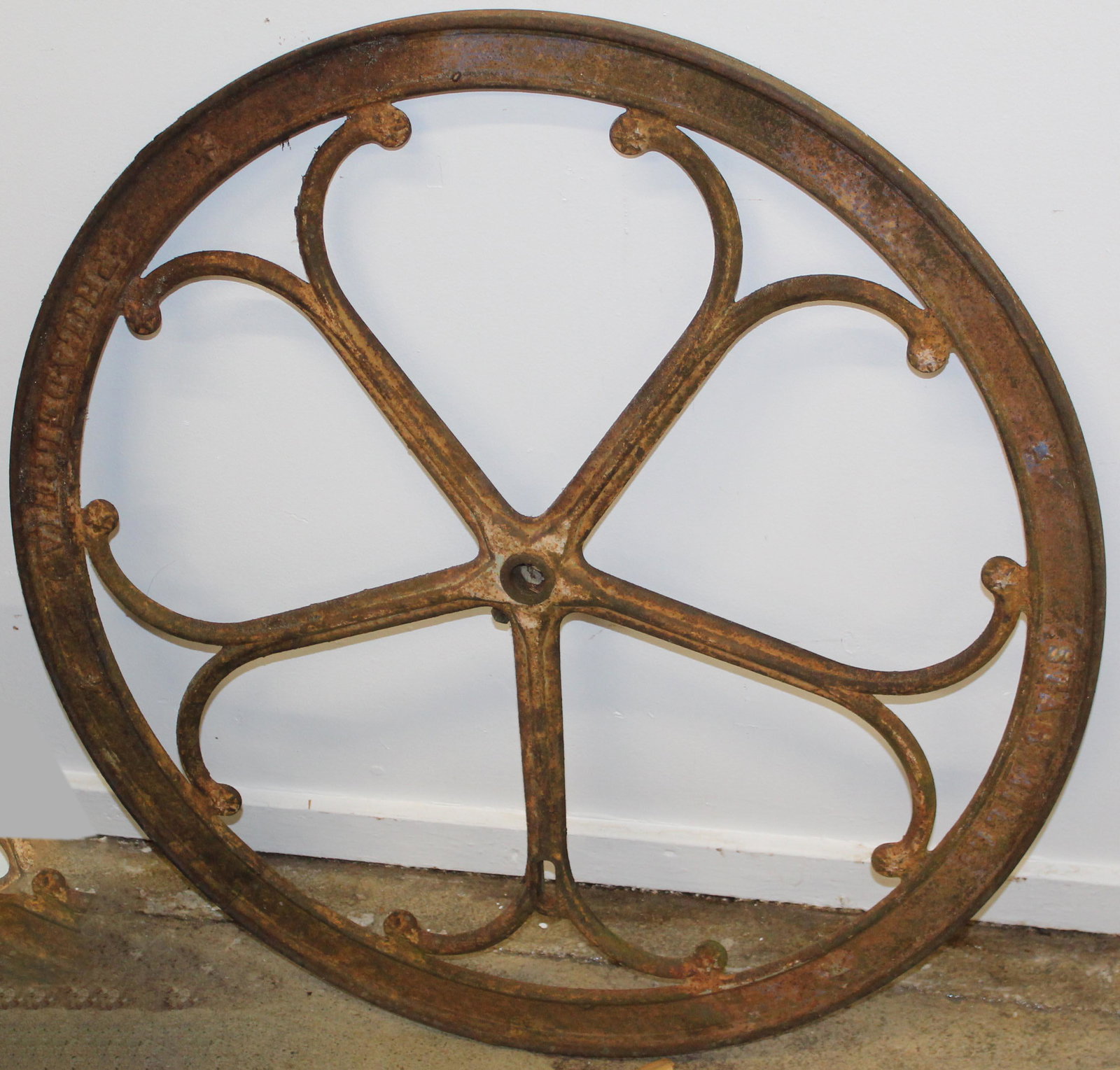 Cast Iron Star Mill Flywheel: 35" diameter cast iron star mill flywheel with embossed decoration. Minor tight crack
