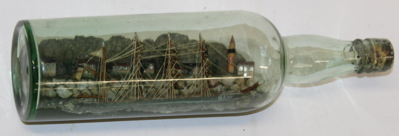 Early 20th c Ship in a Bottle: Early 20th c ship-in-a-bottle, with diorama background, overall length 12"