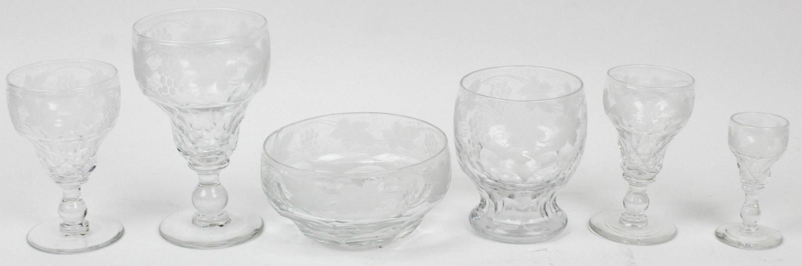 57 pcs. 19th c. European Cut and Etched Stemware: 57 pcs. 19th c. European stemware with etched grape and vine motif, and cut honeycomb pattern bowls including 7 large wines, 3 smaller wines, 9 sherry or dessert wine glasses, 10 aperitifs, 7 cordials
