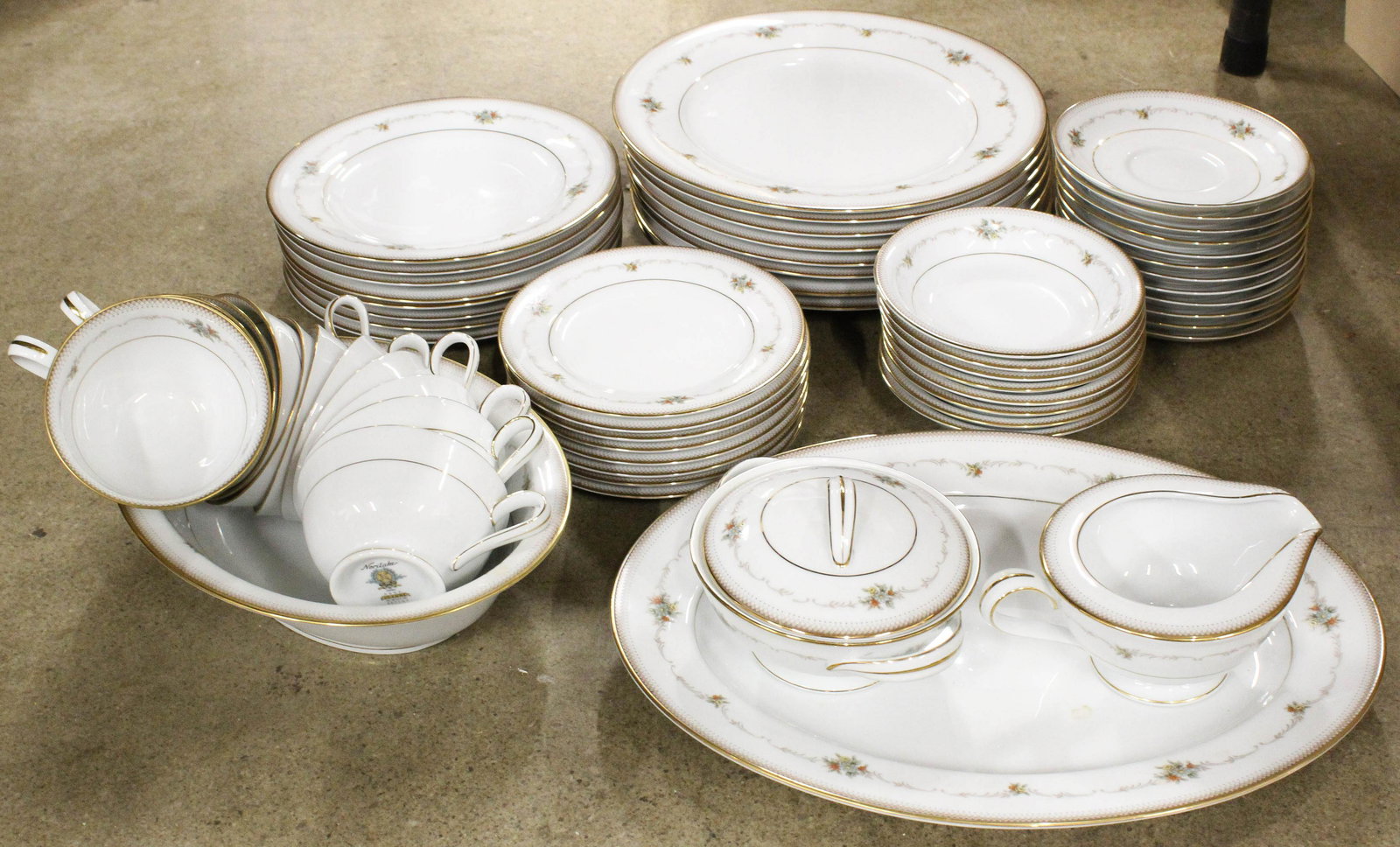 59 pcs. Noritake Joanne Porcelain Dinnerware: 59 pcs. Noritake "Joanne" pattern porcelain dinnerware including sugar and creamer, oval serving dish, serving platter, dinner plates, cups and saucers, bread plates, side bowls, dessert plates, a ser