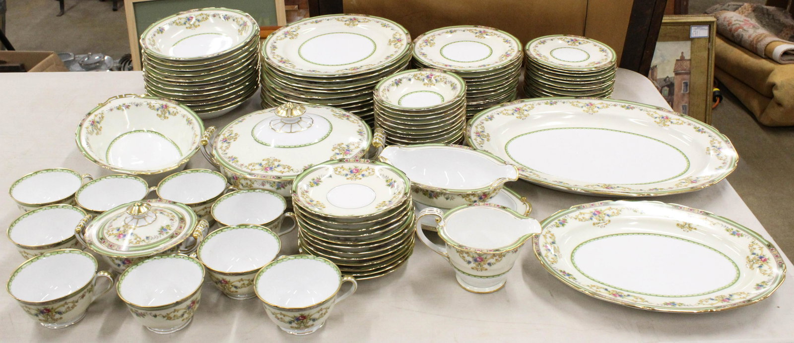 85 pcs. Noritake Florola Porcelain Dinnerware: approx. 85 pcs. Noritake "Florola" pattern porcelain dinnerware including sugar and creamer, covered serving dishes, dinner plates, side dishes, etc. -some pieces with rim chips