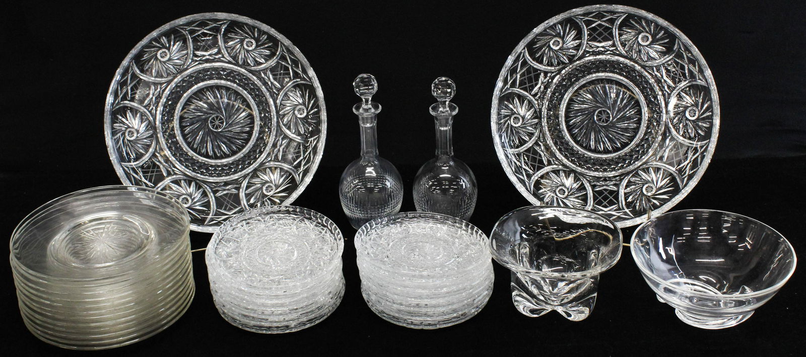 Pair of Baccarat Decanters, Cut Glass Plates: Pair of signed Baccarat French crystal decanters, 12 wheel cut luncheon plates, two Eastern European lead crystal cake plates with 10 matching dessert plates, signed Steuben bowl (chipped), Orrefors b