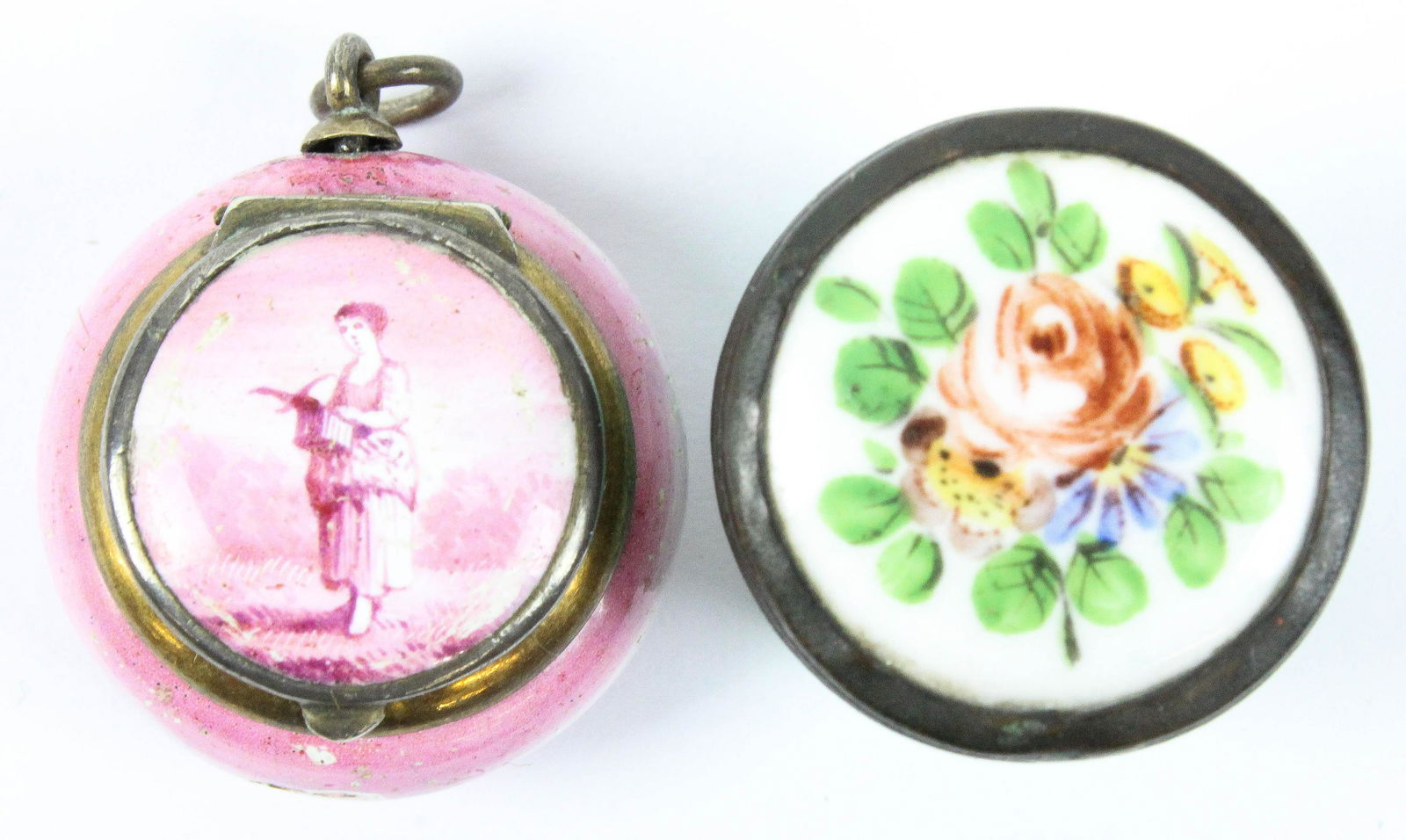 Two 19th c Battersea pill boxes: Two 19th c battersea pill boxe. One having floral enamel decorated top, mirrored interior 22 mm diameter & 18 mm high. One vinaigrette pendant in red enamel with lid having full length portrait and re