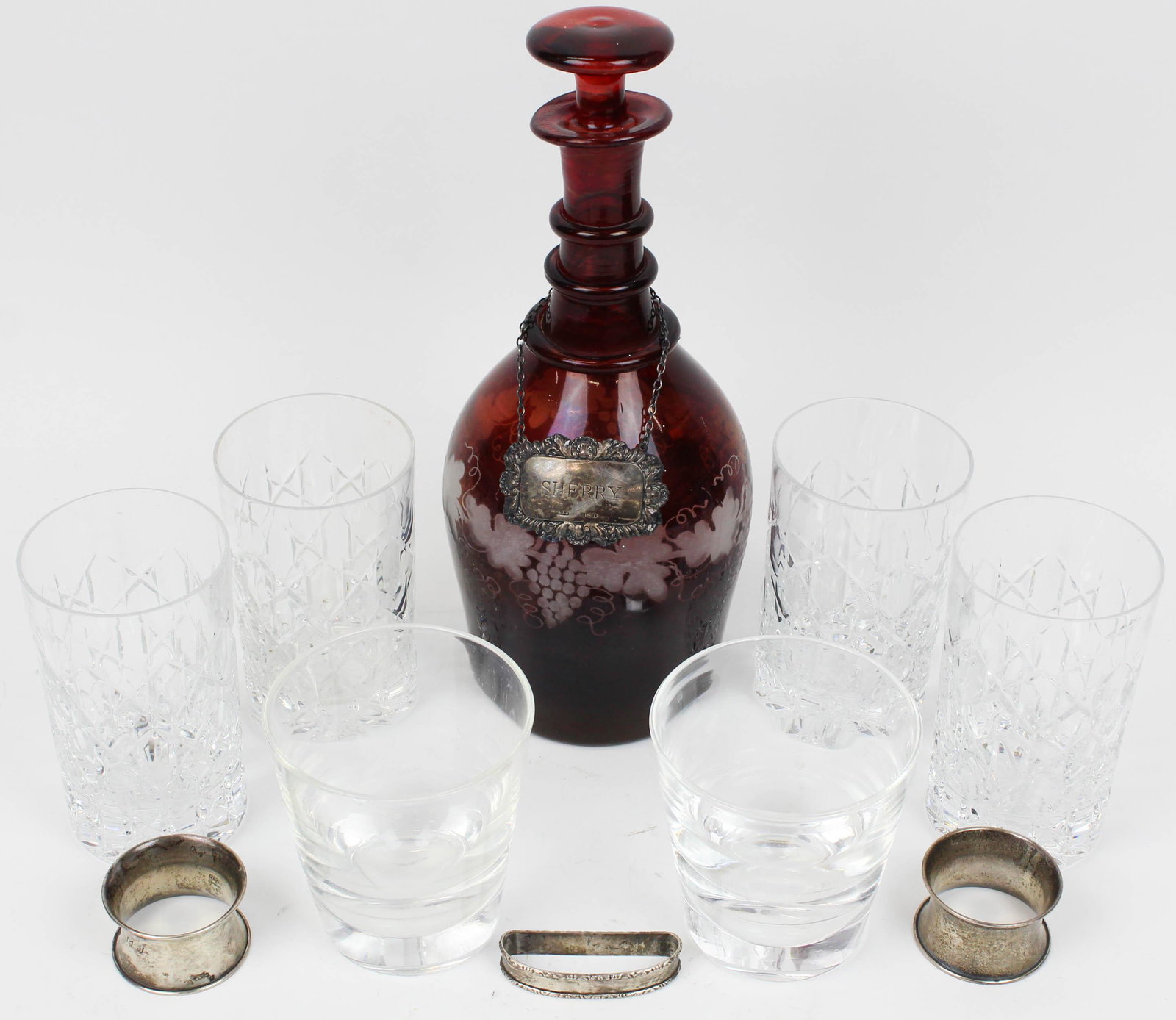 Steuben, Tiffany Glass and Sterling Items: Group of glass and silver items including a pair of signed Steuben rocks glasses 4", 4 signed Tiffany & Co. crystal tumblers 5", Bohemian ruby flashed cut to clear decanter with Birmingham sterling Sh