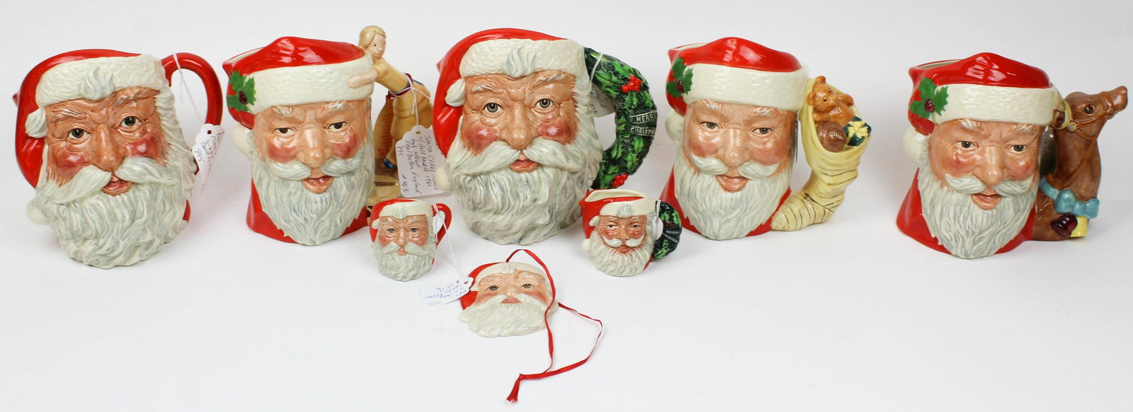 8 Royal Doulton Santa Claus Porcelain Items: 8 Royal Doulton Santa Claus Porcelain Items including five toby character jugs (one artist signed), two mini tobys, and christmas tree ornament ht. 3"-7.5"
