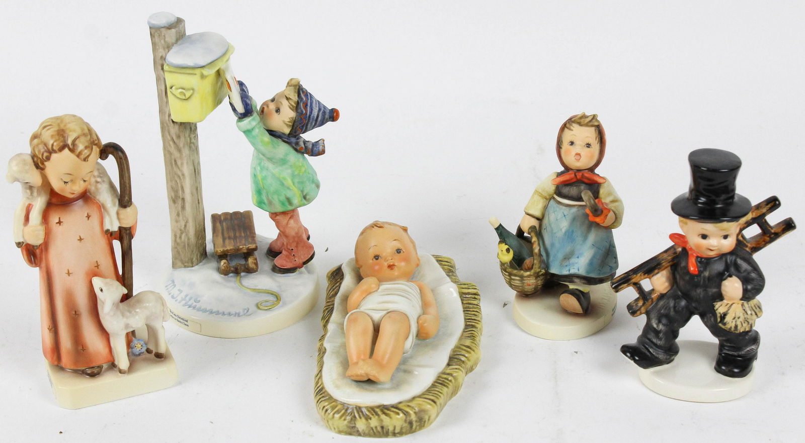Group of 5 Hummel Porcelain Figurines: Group of 6 Goebel Hummel Porcelain Figurines including full bee mark infant Jesus in manger, "Visiting An Invalid". "Letter To Santa Claus", chimney sweep, the good shepherd. Ht. 2.5"-7.5"